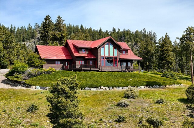 251 S Eighty Dr, Somers, MT 59932 - back of property with a wooded view and metal roof