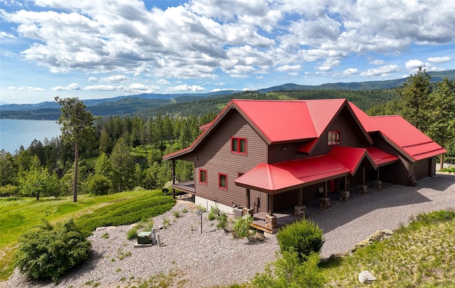 251 S Eighty Dr, Somers, MT 59932 - view of home's exterior with a metal roof, a wooded view, and a water and mountain view