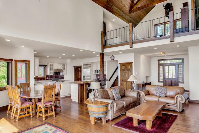 251 S Eighty Dr, Somers, MT 59932 - living area with stairway, light wood finished floors, plenty of natural light, high vaulted ceiling, and wood ceiling with exposed beams