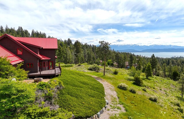 251 S Eighty Dr, Somers, MT 59932 - view of yard featuring a deck with mountain view and a wooded view