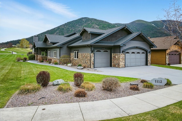 1112 Anglers Bend Way, Missoula, MT 59802 - craftsman-style house with a mountain view, stone siding, a front lawn, concrete driveway, and an attached garage