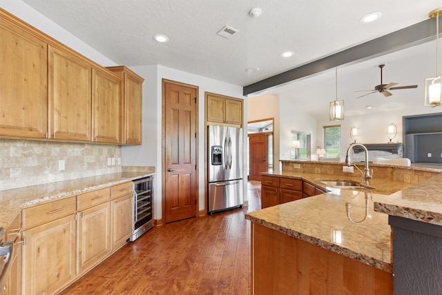 1112 Anglers Bend Way, Missoula, MT 59802 - kitchen featuring stainless steel fridge with ice dispenser, beverage cooler, a sink, decorative backsplash, and wood finished floors