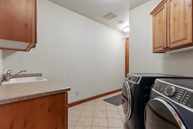 1112 Anglers Bend Way, Missoula, MT 59802 - laundry area featuring independent washer and dryer, cabinet space, light tile patterned floors, and baseboards