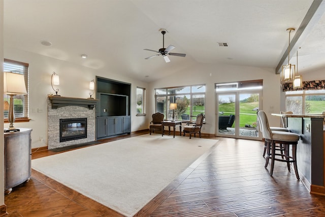 1112 Anglers Bend Way, Missoula, MT 59802 - living room featuring plenty of natural light, a stone fireplace, ceiling fan, lofted ceiling, and wood-type flooring