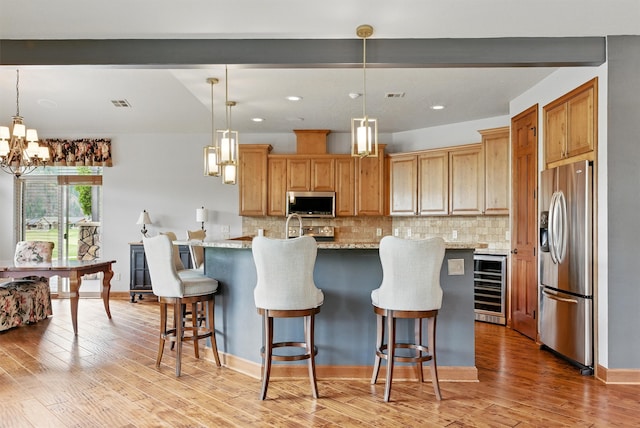 1112 Anglers Bend Way, Missoula, MT 59802 - kitchen featuring stainless steel appliances, wine cooler, backsplash, a chandelier, and recessed lighting