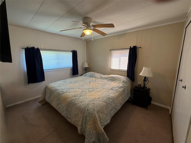 991 Phillips Rd, Helena, MT 59602 - bedroom featuring multiple windows, carpet, ornamental molding, baseboards, and wooden walls