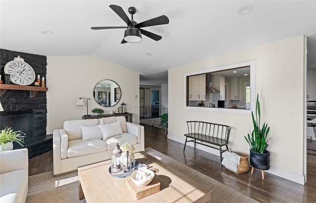1683 Foxtail Dr, Kalispell, MT 59901 - living area featuring wood finished floors, lofted ceiling, a fireplace, and a ceiling fan