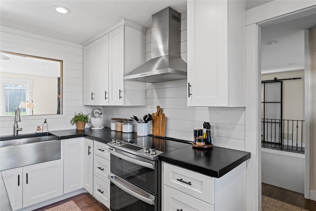 1683 Foxtail Dr, Kalispell, MT 59901 - kitchen featuring wall chimney range hood, double oven range, dark countertops, dark wood-style floors, and white cabinetry