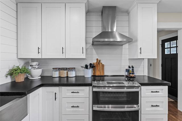 1683 Foxtail Dr, Kalispell, MT 59901 - kitchen with double oven range, wall chimney range hood, dark countertops, white cabinets, and dark wood-style floors