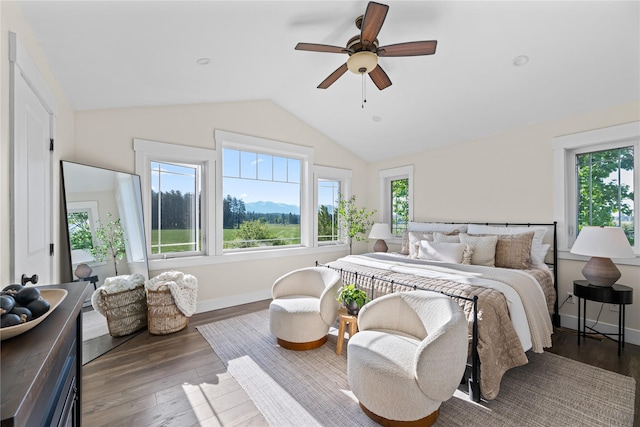 1683 Foxtail Dr, Kalispell, MT 59901 - bedroom with multiple windows, vaulted ceiling, wood finished floors, and ceiling fan