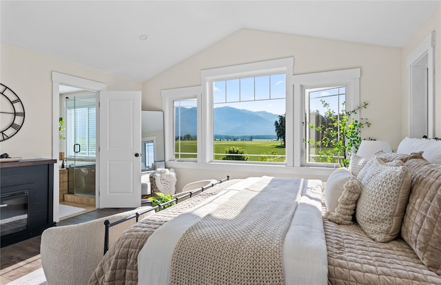 1683 Foxtail Dr, Kalispell, MT 59901 - bedroom featuring wood finished floors, vaulted ceiling, multiple windows, and a mountain view