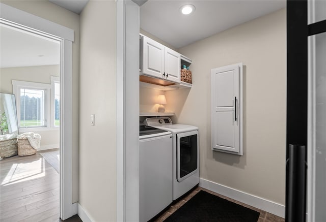1683 Foxtail Dr, Kalispell, MT 59901 - washroom featuring washing machine and clothes dryer, cabinet space, dark wood-type flooring, and recessed lighting