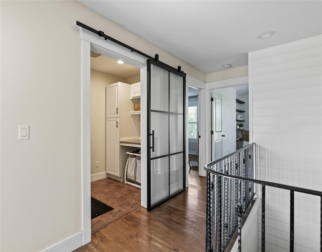 1683 Foxtail Dr, Kalispell, MT 59901 - hall with a barn door, dark wood-style flooring, an upstairs landing, and recessed lighting