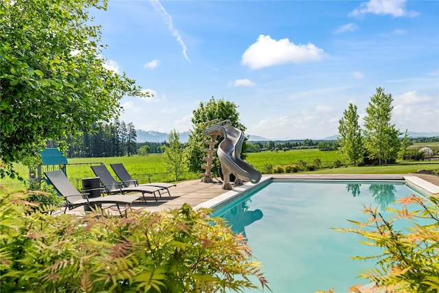 1683 Foxtail Dr, Kalispell, MT 59901 - outdoor pool with a water slide, a mountain view, and a yard