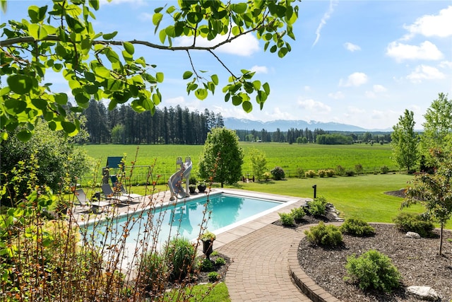 1683 Foxtail Dr, Kalispell, MT 59901 - swimming pool featuring a water slide, a view of countryside, a mountain view, and a patio