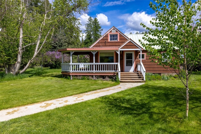 221 Kauffman Ln, Kalispell, MT 59901 - view of front of house with covered porch, a front yard, and a metal roof