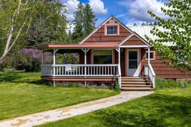 221 Kauffman Ln, Kalispell, MT 59901 - view of front of property featuring covered porch, a front lawn, and a metal roof