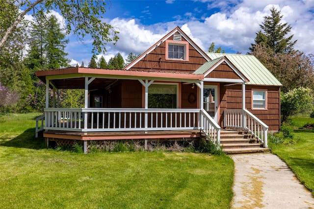 221 Kauffman Ln, Kalispell, MT 59901 - view of front facade featuring covered porch, a front lawn, and metal roof