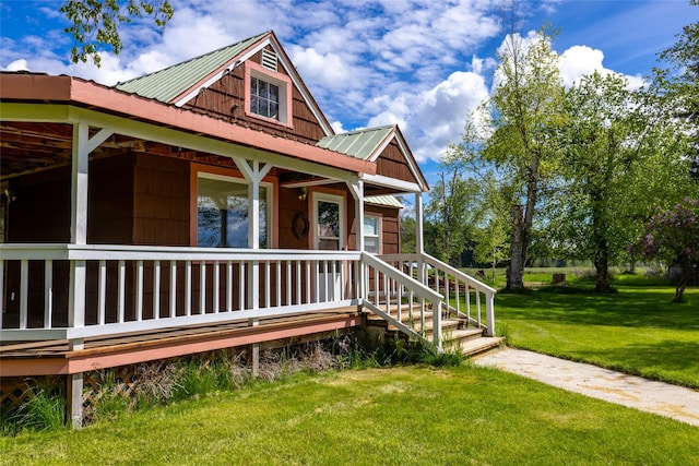 221 Kauffman Ln, Kalispell, MT 59901 - view of front of home with a front yard, a metal roof, and covered porch