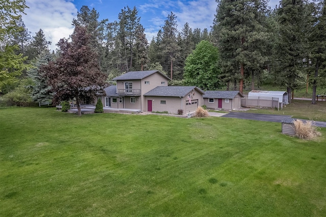 33958 Connolly Way, Polson, MT 59860 - view of front of home featuring asphalt driveway, a garage, and a front yard