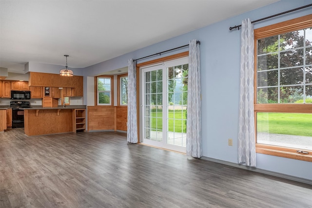 33958 Connolly Way, Polson, MT 59860 - kitchen with black appliances, dark countertops, healthy amount of natural light, and wood finished floors
