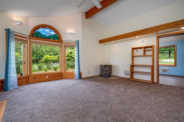 33958 Connolly Way, Polson, MT 59860 - unfurnished living room featuring a wood stove, beamed ceiling, carpet flooring, plenty of natural light, and high vaulted ceiling
