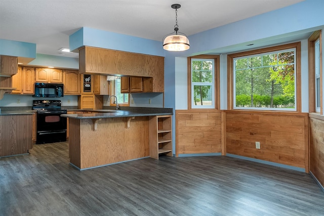 33958 Connolly Way, Polson, MT 59860 - kitchen featuring black appliances, dark countertops, open shelves, dark wood-style floors, and wainscoting