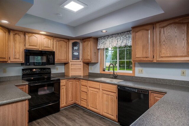 33958 Connolly Way, Polson, MT 59860 - kitchen featuring black appliances, a raised ceiling, dark wood-type flooring, recessed lighting, and glass insert cabinets