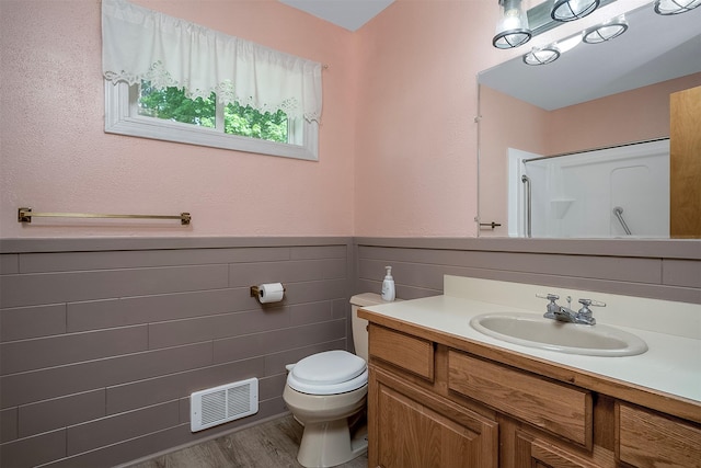 33958 Connolly Way, Polson, MT 59860 - full bath with vanity, a shower, wainscoting, and wood finished floors