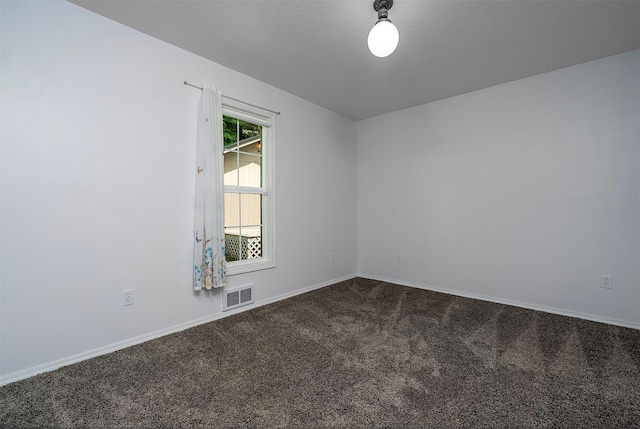 33958 Connolly Way, Polson, MT 59860 - empty room featuring dark colored carpet and baseboards