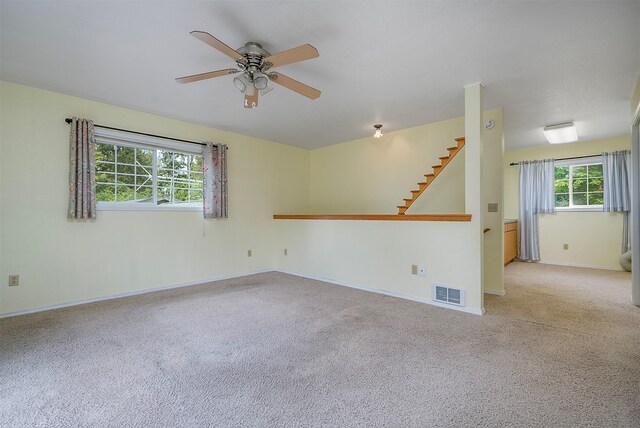 33958 Connolly Way, Polson, MT 59860 - unfurnished room with light carpet, a ceiling fan, and stairway