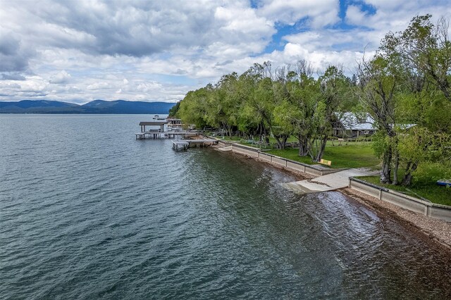33958 Connolly Way, Polson, MT 59860 - water view with a boat ramp, a dock, and a mountain backdrop