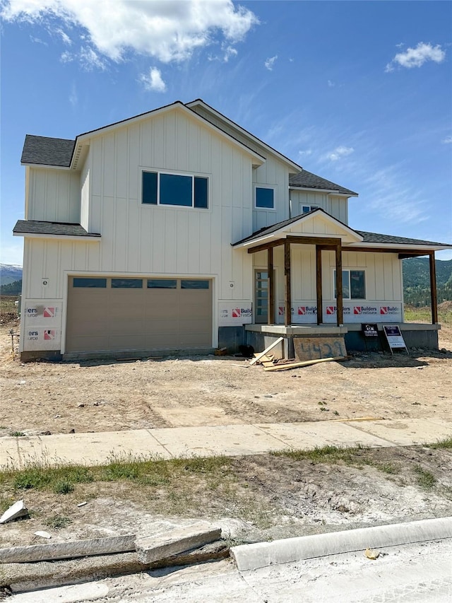 4429 Harrison Scott Dr, Missoula, MT 59803 - view of front of house with a garage, roof with shingles, board and batten siding, and dirt driveway