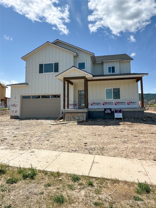 4429 Harrison Scott Dr, Missoula, MT 59803 - view of front facade featuring an attached garage, driveway, board and batten siding, and a shingled roof