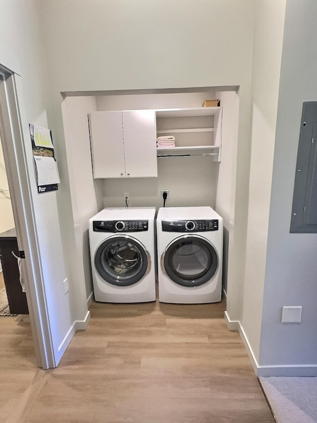 100 Woodlands Way Unit W-204, Kalispell, MT 59901 - washroom featuring washer and clothes dryer, electric panel, cabinet space, and light wood-style flooring