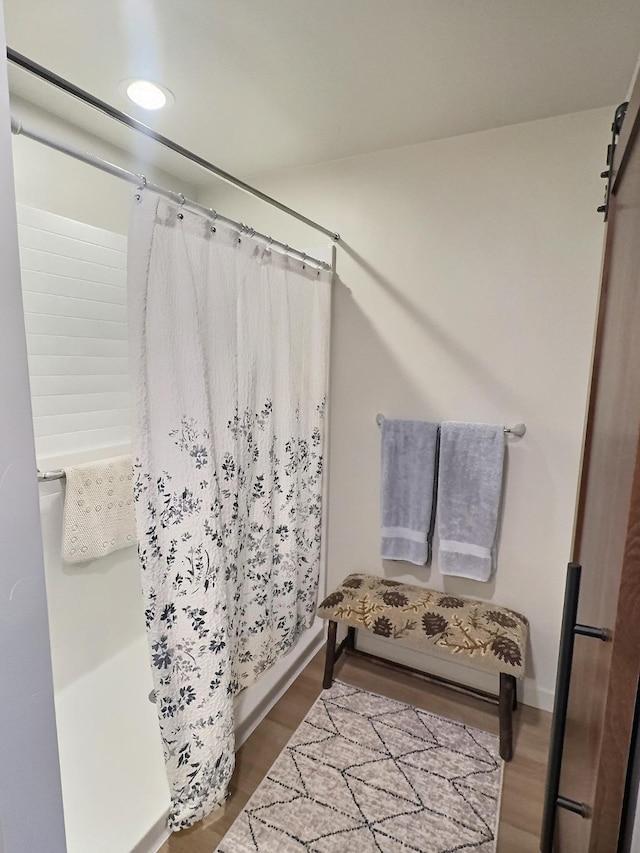 100 Woodlands Way Unit W-204, Kalispell, MT 59901 - full bathroom featuring wood finished floors and shower / bath combo with shower curtain
