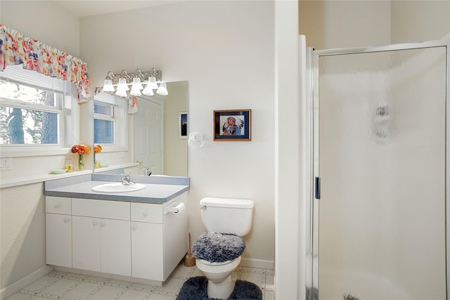 29137 Rocky Point Rd, Polson, MT 59860 - bathroom featuring vanity, a shower stall, toilet, and baseboards