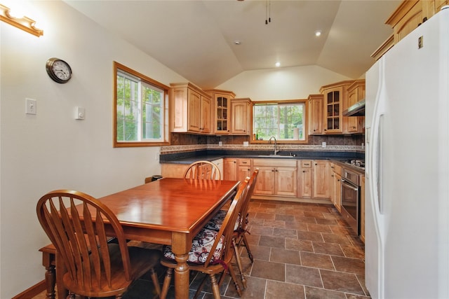 29137 Rocky Point Rd, Polson, MT 59860 - kitchen with freestanding refrigerator, a sink, stainless steel oven, dark countertops, and tasteful backsplash
