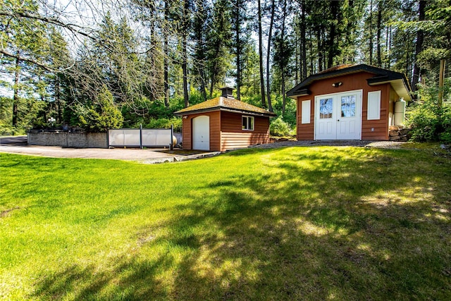29137 Rocky Point Rd, Polson, MT 59860 - view of grassy yard featuring an outdoor structure and a garage