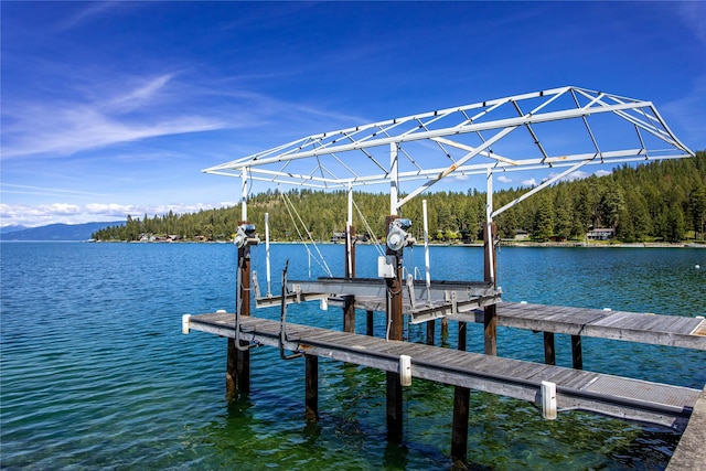 29137 Rocky Point Rd, Polson, MT 59860 - dock area with boat lift, a water view, and a view of trees