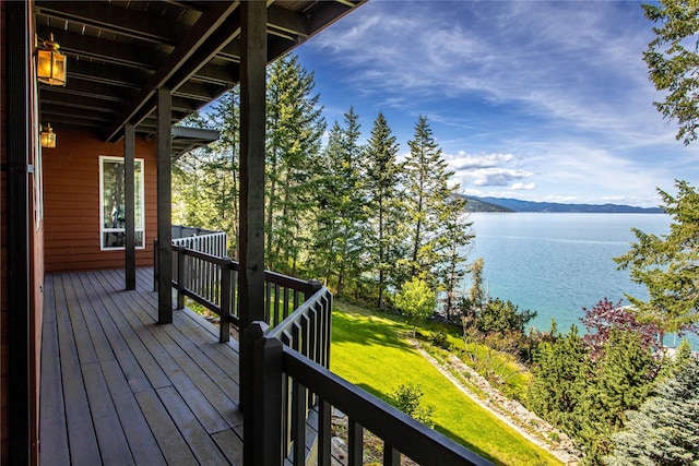 29137 Rocky Point Rd, Polson, MT 59860 - wooden terrace with a water and mountain view and a lawn