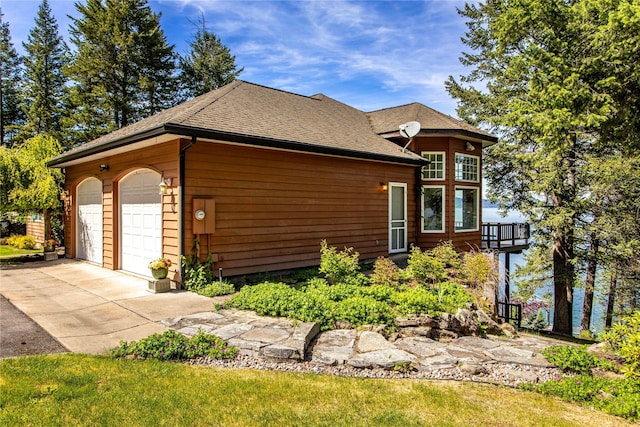 29137 Rocky Point Rd, Polson, MT 59860 - view of front of home featuring a garage and roof with shingles