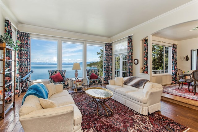 29137 Rocky Point Rd, Polson, MT 59860 - living area featuring arched walkways, wood-type flooring, ornamental molding, and a water view