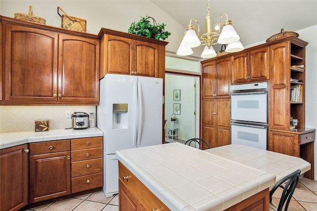 29137 Rocky Point Rd, Polson, MT 59860 - kitchen featuring white appliances, lofted ceiling, a chandelier, light tile patterned flooring, and open shelves