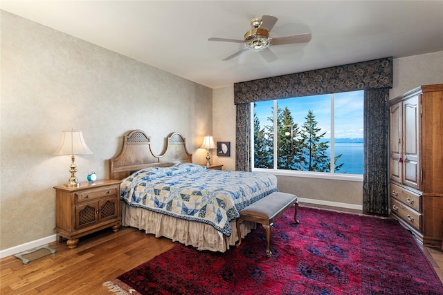29137 Rocky Point Rd, Polson, MT 59860 - bedroom featuring wood finished floors, baseboards, and a ceiling fan