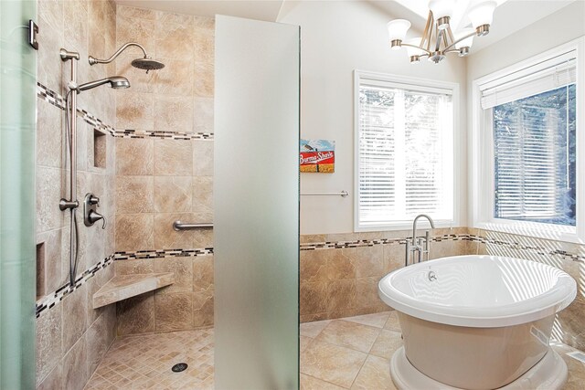 29137 Rocky Point Rd, Polson, MT 59860 - full bath with a stall shower, a freestanding bath, a chandelier, a wainscoted wall, and tile patterned floors