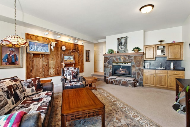 29137 Rocky Point Rd, Polson, MT 59860 - carpeted living area featuring a sink, rail lighting, and a fireplace