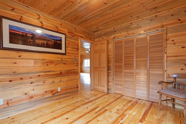 15530 S Sperry Grade Rd, Greenough, MT 59823 - unfurnished bedroom with wood ceiling, wood walls, light wood-style floors, and a closet
