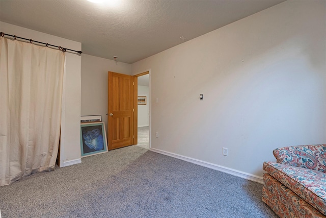 15530 S Sperry Grade Rd, Greenough, MT 59823 - unfurnished bedroom featuring carpet, baseboards, and a textured ceiling