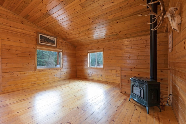 15530 S Sperry Grade Rd, Greenough, MT 59823 - unfurnished room with a wood stove, vaulted ceiling, wood walls, light wood finished floors, and wood ceiling